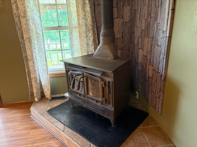 21572 Lawrence Unit 1240, Aurora, MO 65605 - detailed view of a wood stove and wood finished floors