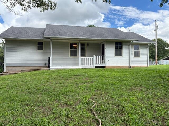 21572 Lawrence Unit 1240, Aurora, MO 65605 - back of property with covered porch, a lawn, and a shingled roof