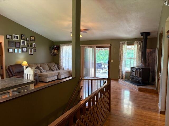 21572 Lawrence Unit 1240, Aurora, MO 65605 - living room with a wood stove, wood finished floors, ceiling fan, and lofted ceiling