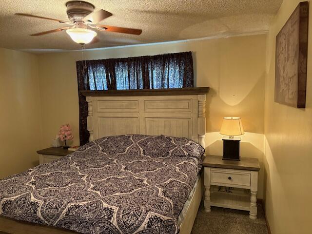 21572 Lawrence Unit 1240, Aurora, MO 65605 - carpeted bedroom featuring a textured ceiling and a ceiling fan