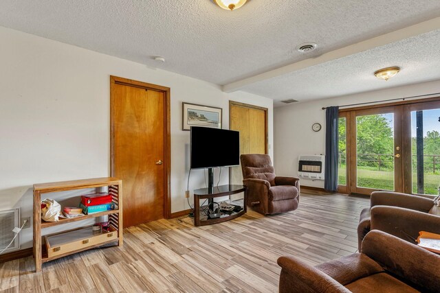 4949 S 196th Rd, Halfway, MO 65663 - living area with heating unit, a textured ceiling, and light wood finished floors