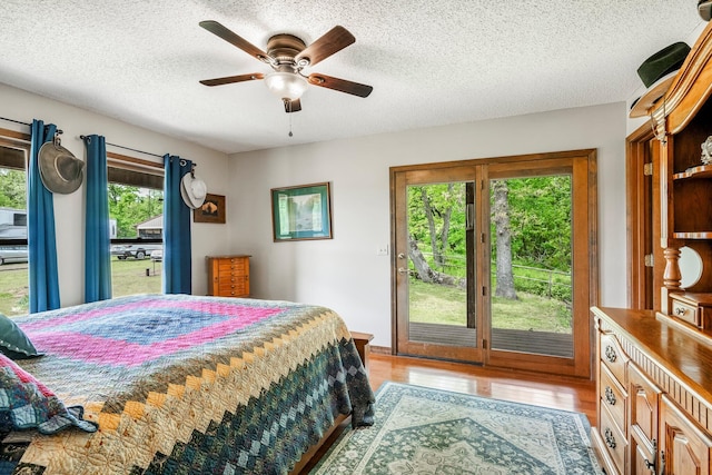 4949 S 196th Rd, Halfway, MO 65663 - bedroom with access to exterior, wood finished floors, a textured ceiling, and a ceiling fan