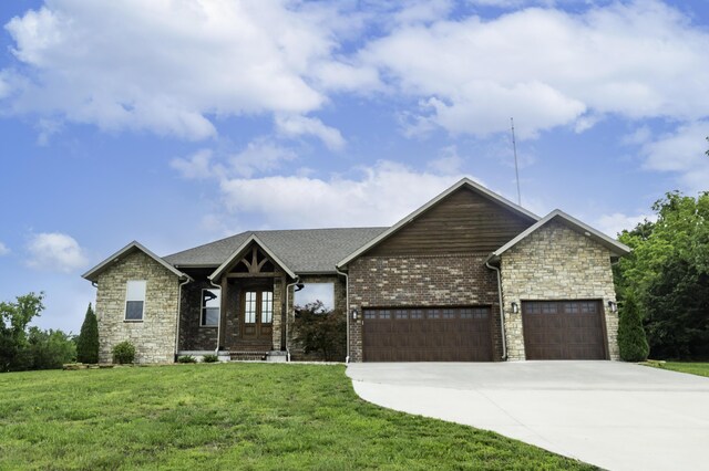 416 W Saddle Club Rd, Fair Grove, MO 65648 - view of front of home featuring a front yard, a garage, concrete driveway, and stone siding