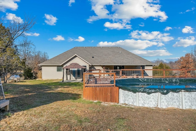 416 W Saddle Club Rd, Fair Grove, MO 65648 - back of property featuring a covered pool, a yard, and a shingled roof