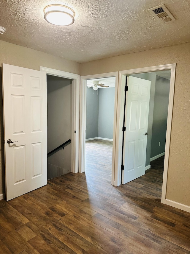 652 W Hovey St, Springfield, MO 65802 - hallway featuring dark wood-type flooring and a textured ceiling