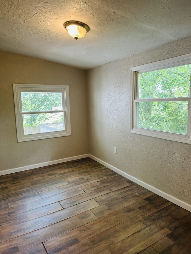 652 W Hovey St, Springfield, MO 65802 - unfurnished room with plenty of natural light, wood finished floors, and a textured wall