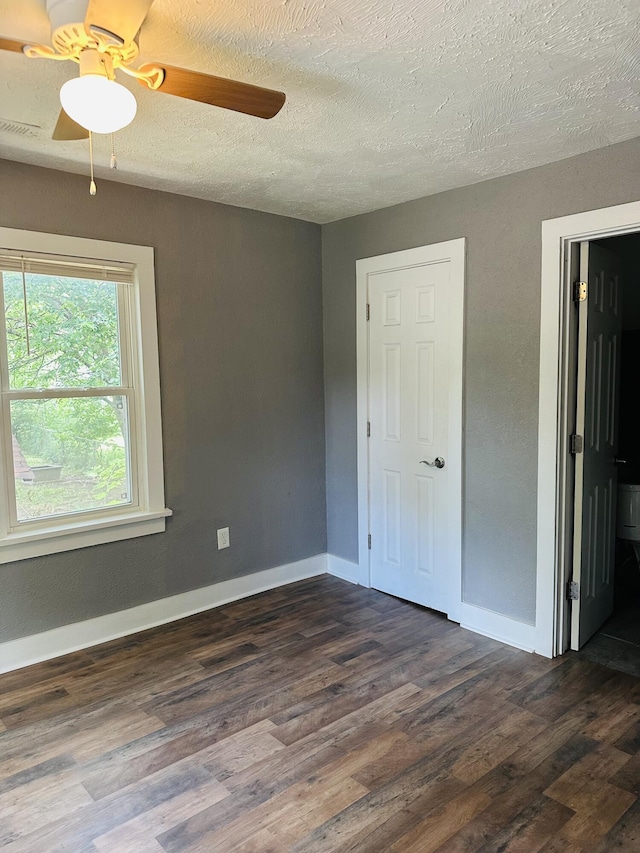 652 W Hovey St, Springfield, MO 65802 - empty room with a ceiling fan, a textured ceiling, and dark wood finished floors