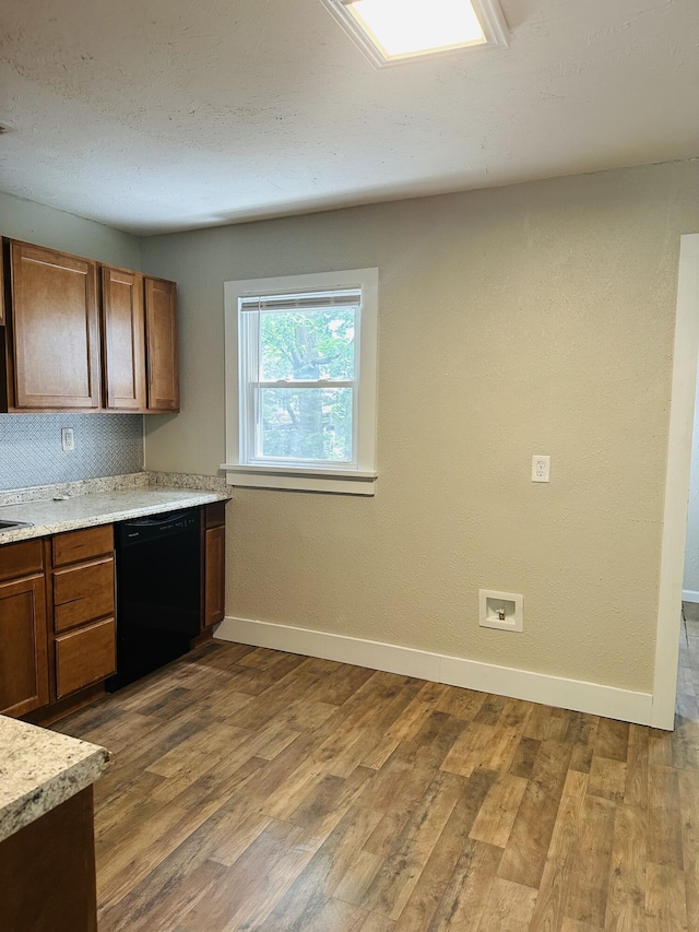 652 W Hovey St, Springfield, MO 65802 - kitchen featuring dishwasher, dark wood-style flooring, and light countertops