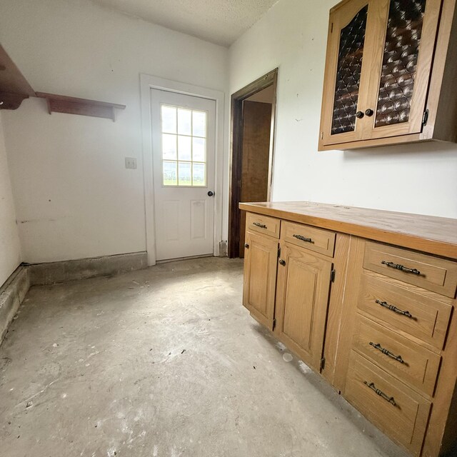5435 State Highway 14, Sparta, MO 65753 - interior space with butcher block countertops, unfinished concrete flooring, and glass insert cabinets