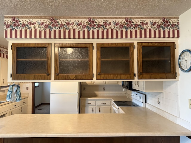 5435 State Highway 14, Sparta, MO 65753 - kitchen featuring white appliances, light countertops, decorative backsplash, and glass insert cabinets