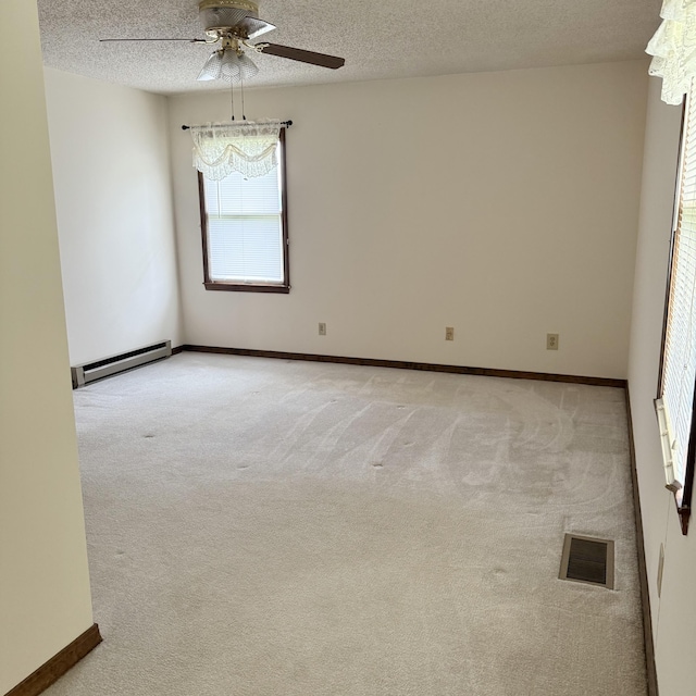 5435 State Highway 14, Sparta, MO 65753 - empty room with a baseboard heating unit, a ceiling fan, a textured ceiling, and light carpet