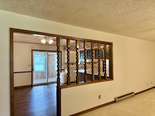 5435 State Highway 14, Sparta, MO 65753 - stairway featuring a baseboard radiator, a textured ceiling, and wood finished floors