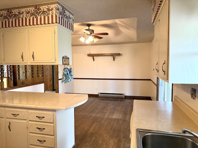 5435 State Highway 14, Sparta, MO 65753 - kitchen featuring ceiling fan, a baseboard radiator, light countertops, a textured ceiling, and dark wood-style flooring