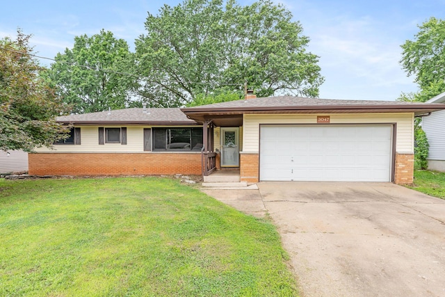 3047 S Ferguson Ave, Springfield, MO 65807 - view of front of property with brick siding, a front lawn, an attached garage, and driveway