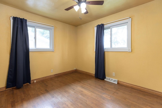 3047 S Ferguson Ave, Springfield, MO 65807 - spare room featuring wood finished floors and a ceiling fan