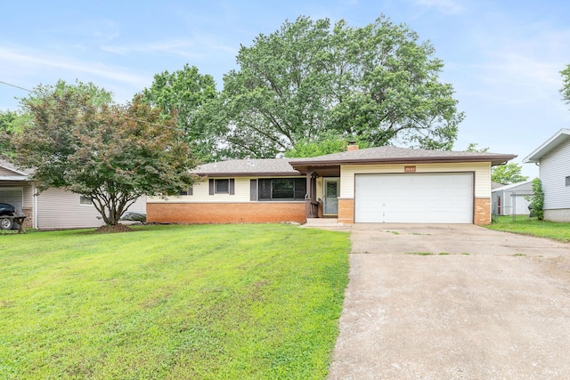 3047 S Ferguson Ave, Springfield, MO 65807 - view of front of home with brick siding, a garage, a front yard, and driveway