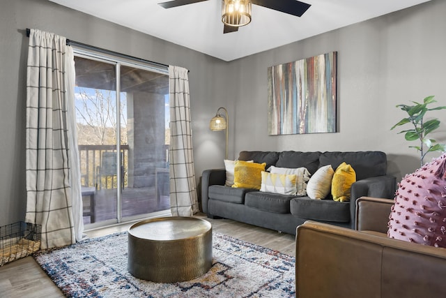 living area featuring wood finished floors and ceiling fan