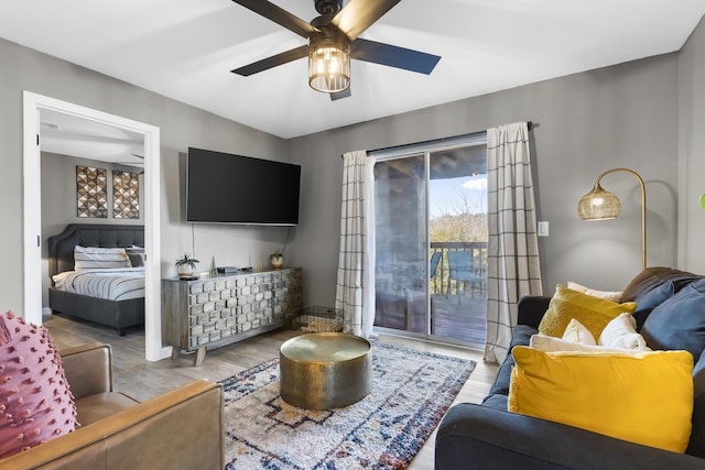 living room featuring a ceiling fan and wood finished floors