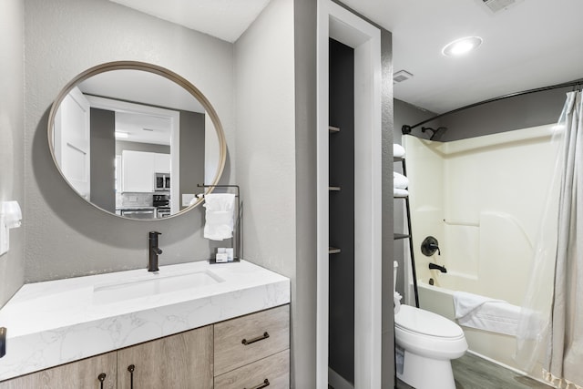 bathroom featuring vanity, shower / bath combination, and wood finished floors