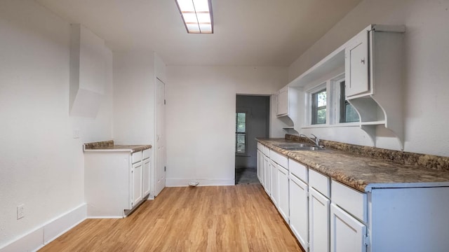 220 S 3rd St, Thayer, MO 65791 - kitchen featuring light wood-type flooring, white cabinetry, and dark countertops