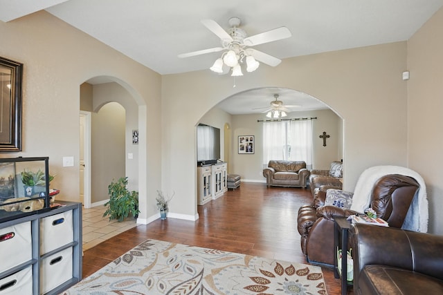 1925 Sylvan Ave, Neosho, MO 64850 - living room with a ceiling fan, wood finished floors, and arched walkways