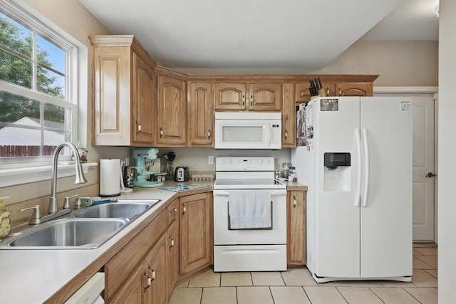 1925 Sylvan Ave, Neosho, MO 64850 - kitchen with white appliances, light tile patterned flooring, light countertops, and brown cabinets
