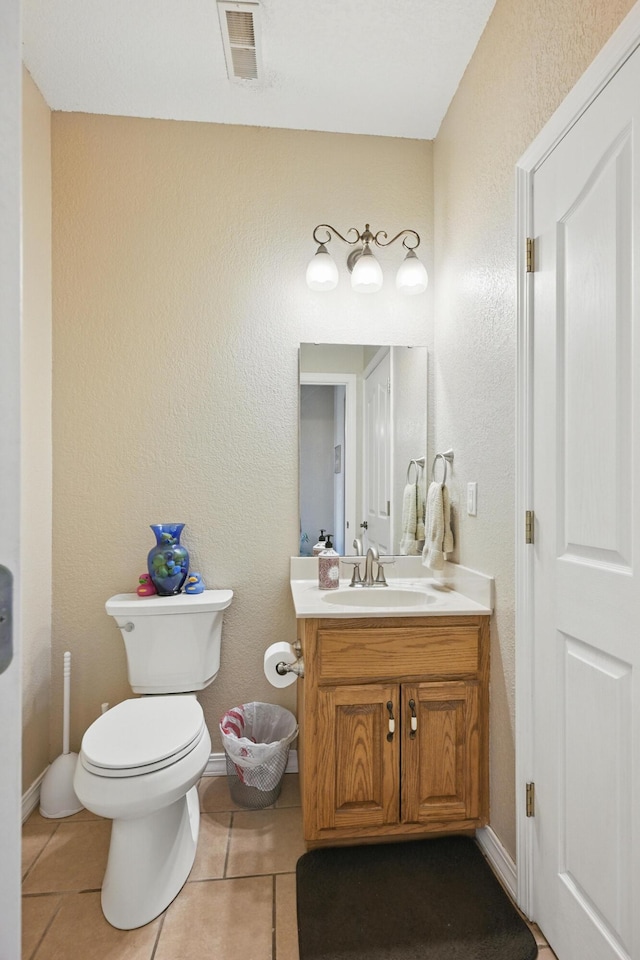 1925 Sylvan Ave, Neosho, MO 64850 - bathroom featuring vanity, tile patterned flooring, and a textured wall