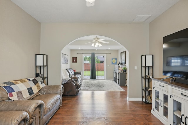 1925 Sylvan Ave, Neosho, MO 64850 - living room featuring arched walkways, ceiling fan, and dark wood-type flooring