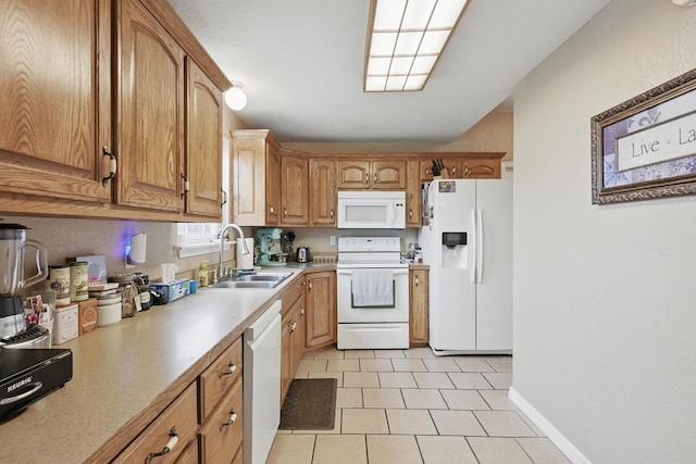 1925 Sylvan Ave, Neosho, MO 64850 - kitchen featuring white appliances, light countertops, light tile patterned floors, and brown cabinets