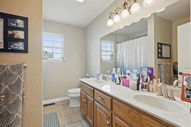 1925 Sylvan Ave, Neosho, MO 64850 - full bathroom featuring healthy amount of natural light, double vanity, tile patterned floors, and a shower with curtain