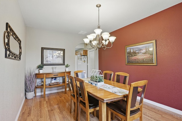 1925 Sylvan Ave, Neosho, MO 64850 - dining area with a chandelier and light wood-type flooring