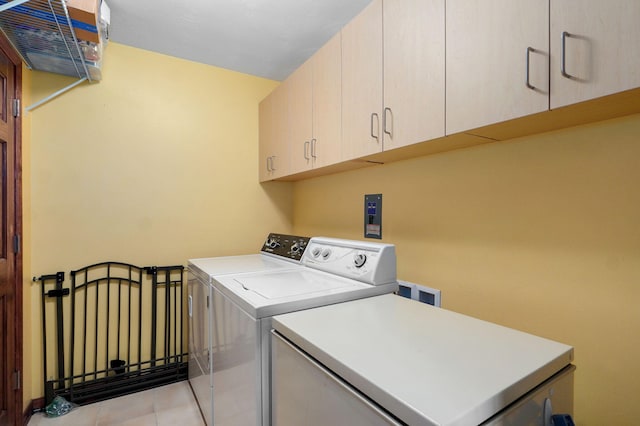3112 E Lomita St, Springfield, MO 65804 - washroom with cabinet space, washing machine and clothes dryer, and light tile patterned floors