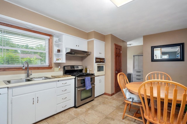 3112 E Lomita St, Springfield, MO 65804 - kitchen with white appliances, under cabinet range hood, white cabinets, light countertops, and light tile patterned floors