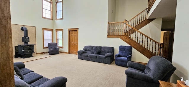 3889 E State Highway Kk, Fair Grove, MO 65648 - carpeted living area with a towering ceiling, a wood stove, and stairs
