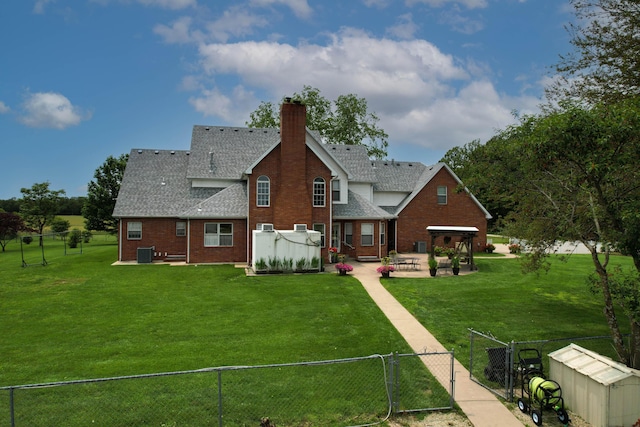 3889 E State Highway Kk, Fair Grove, MO 65648 - back of property with a fenced backyard, a gate, a patio, a shingled roof, and brick siding