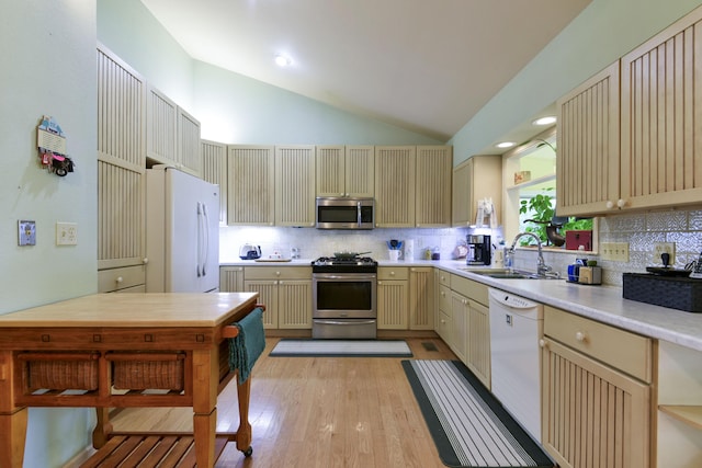 164 Sweet Home Trl, Theodosia, MO 65761 - kitchen featuring appliances with stainless steel finishes, cream cabinetry, lofted ceiling, and backsplash
