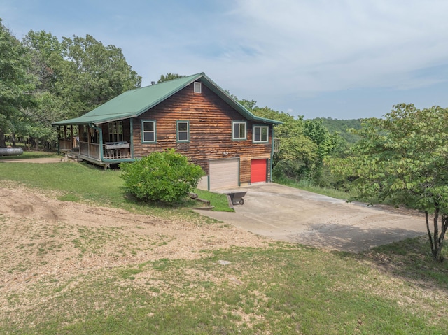 164 Sweet Home Trl, Theodosia, MO 65761 - view of side of home with driveway, an attached garage, and a yard