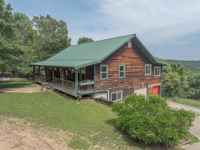 164 Sweet Home Trl, Theodosia, MO 65761 - view of side of home featuring a yard, covered porch, driveway, an attached garage, and a metal roof