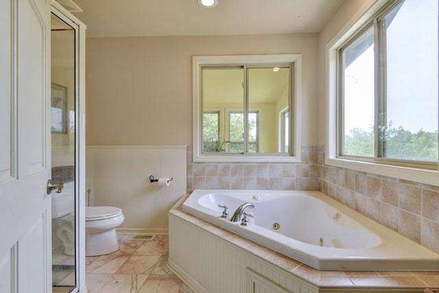 164 Sweet Home Trl, Theodosia, MO 65761 - bathroom with a jetted tub, wainscoting, and marble look tiles