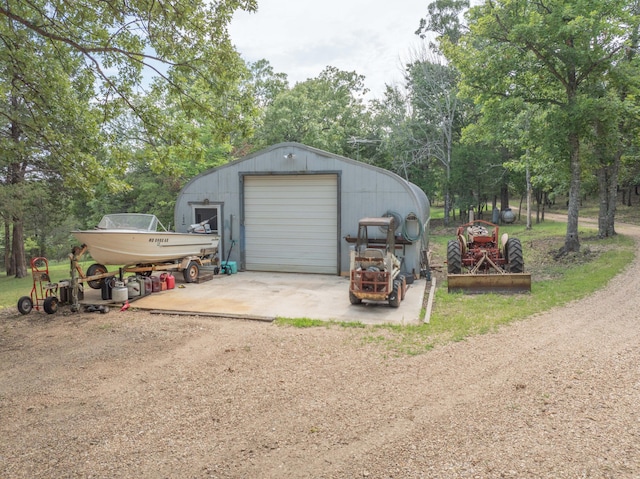164 Sweet Home Trl, Theodosia, MO 65761 - detached garage with dirt driveway and view of scattered trees