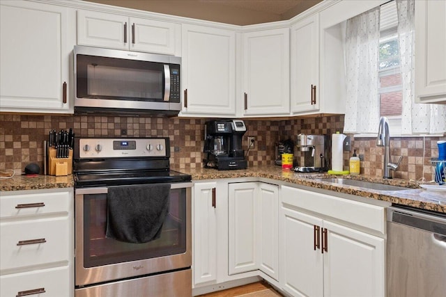 759 S Troy Ave, Springfield, MO 65802 - kitchen featuring appliances with stainless steel finishes, white cabinets, backsplash, and stone counters