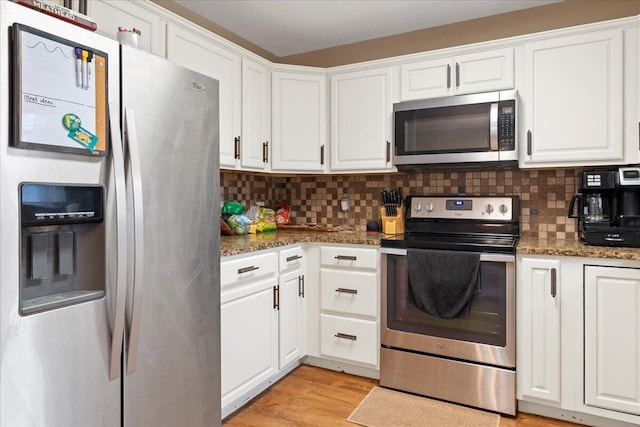 759 S Troy Ave, Springfield, MO 65802 - kitchen featuring stainless steel appliances, white cabinets, backsplash, and dark stone countertops