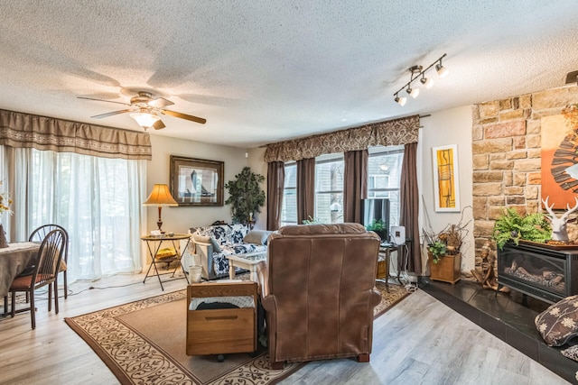 426 Lakewood Rd, Branson, MO 65616 - living area with a textured ceiling, healthy amount of natural light, a ceiling fan, and wood finished floors