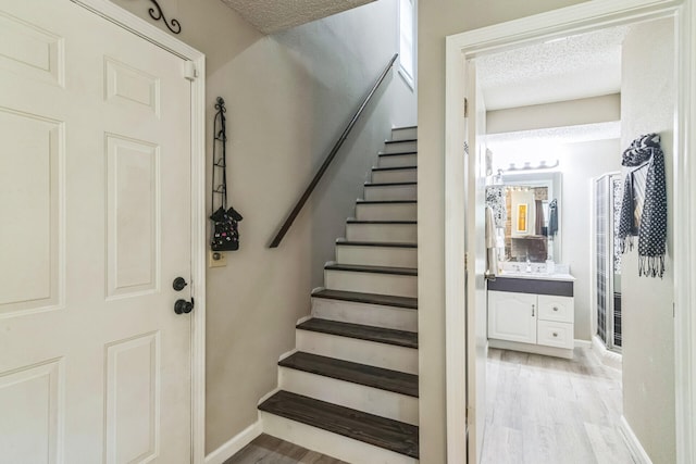 426 Lakewood Rd, Branson, MO 65616 - stairs with wood finished floors and a textured ceiling