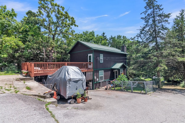426 Lakewood Rd, Branson, MO 65616 - view of home's exterior featuring a chimney, a wooden deck, view of wooded area, and a gate