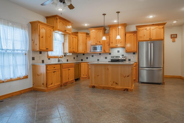 1466 S Natchez Rd, Republic, MO 65738 - kitchen with stainless steel appliances, light countertops, ceiling fan, backsplash, and decorative light fixtures