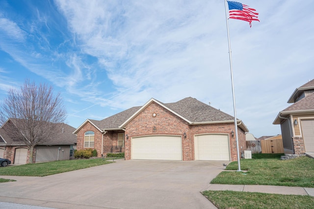 1466 S Natchez Rd, Republic, MO 65738 - view of front of home featuring concrete driveway, an attached garage, brick siding, and a shingled roof