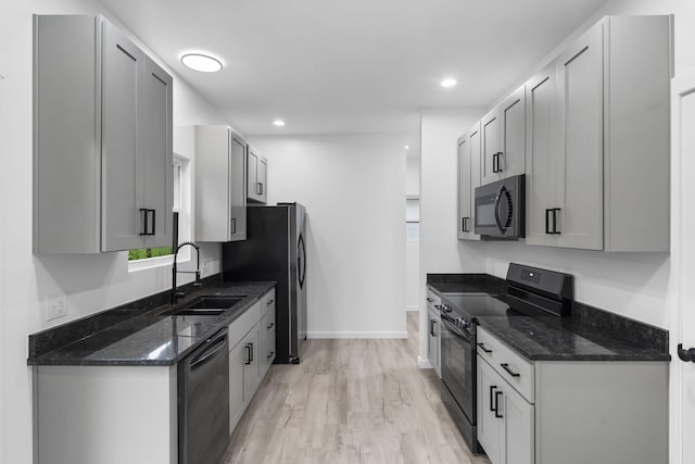804 Iris Ave, Crane, MO 65633 - kitchen with black appliances, light wood-style floors, dark stone countertops, and recessed lighting