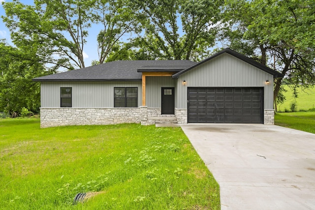 804 Iris Ave, Crane, MO 65633 - view of front of home with stone siding, a garage, a front yard, and driveway