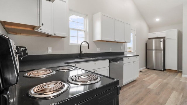 2605 Country Dr, Mountain Grove, MO 65711 - kitchen with stainless steel appliances, healthy amount of natural light, white cabinetry, and lofted ceiling